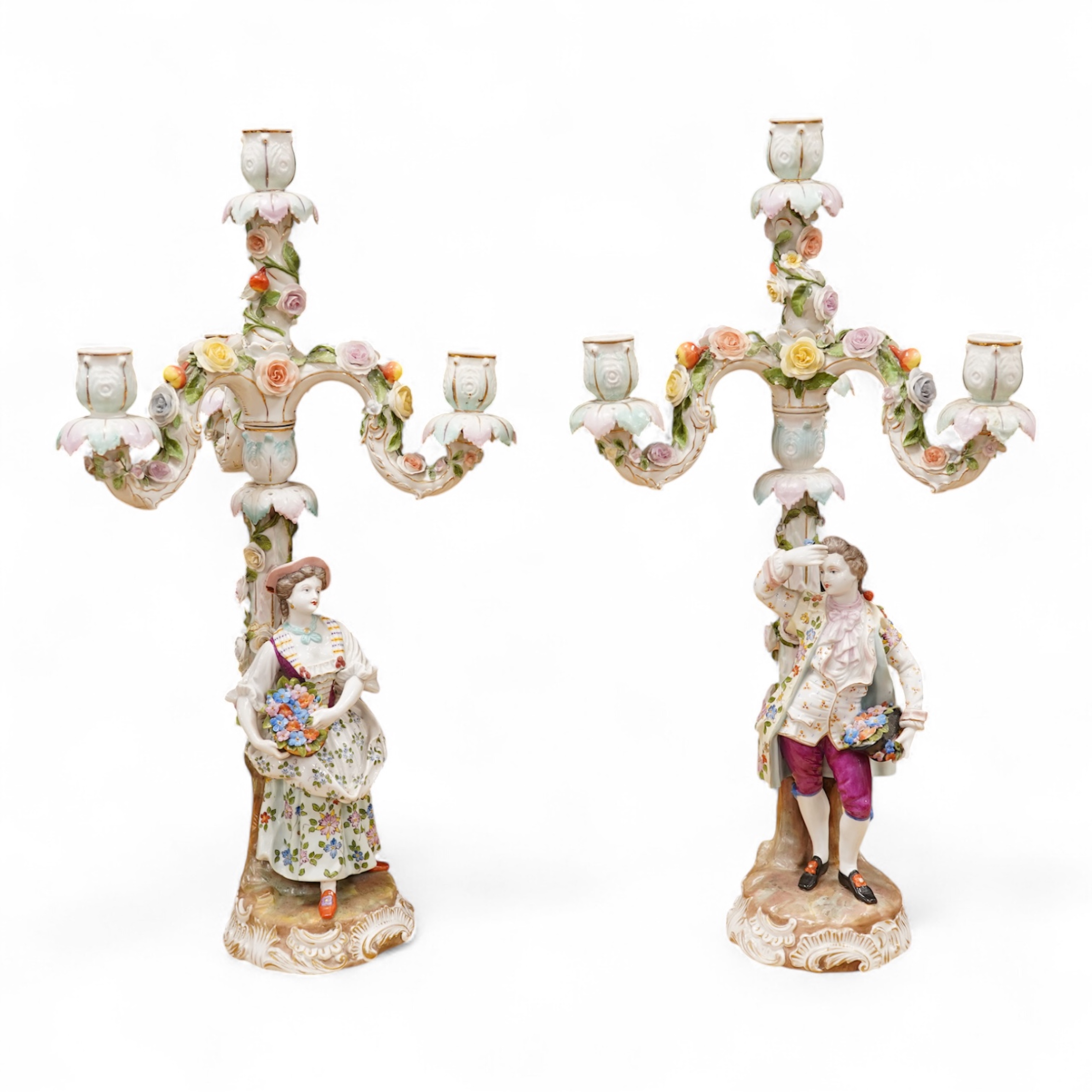 A pair of Volkstedt porcelain figural three branch candelabra with floral encrusted decoration, 51cm high